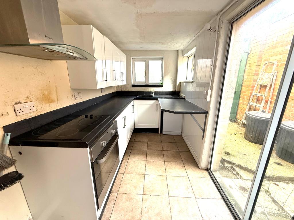Lot: 137 - TWO-BEDROOM HOUSE FOR IMPROVEMENT - Kitchen with access to garden